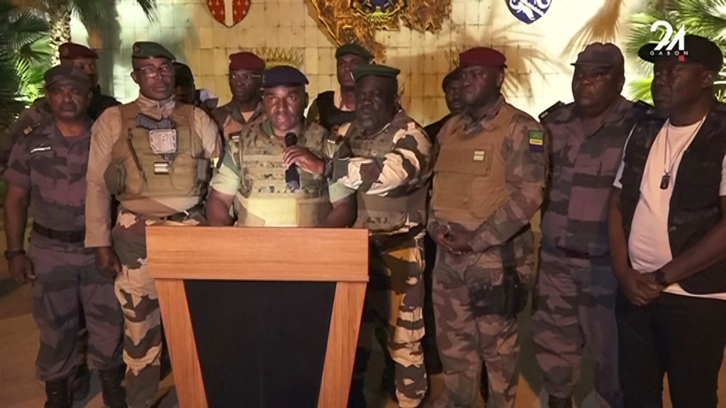 This video grab taken from Gabon 24 shows Gabonese soldiers appearing on television on 30 August, announcing they were putting an end to the current regime and the cancellation of an election that, according to official results, President Ali Bongo Ondimba won. (AFP)