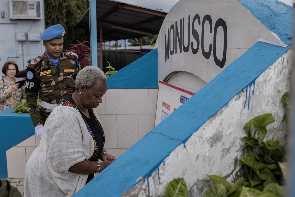 Bintou Keita (R), the head of the United Nations Organization Stabilization Mission in the Democratic Republic of the Congo (MONUSCO), lays a wreath during a ceremony in honour of peacekeepers killed in the line of duty since the mission began, in Goma on 11 March 2023. 