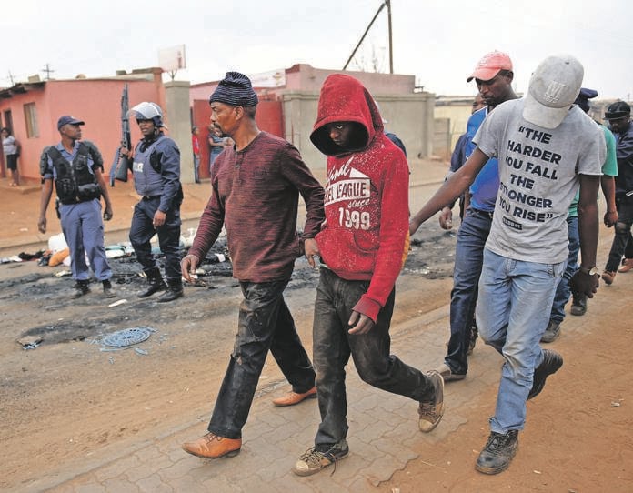 Police arrest a group of locals suspected of causing major unrest in Katlehong following attacks on foreigners at Mandela squatter camp in the township. Picture: Tebogo Letsie