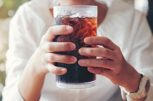 Woman hand giving glass ,Soft drinks with ice, swe