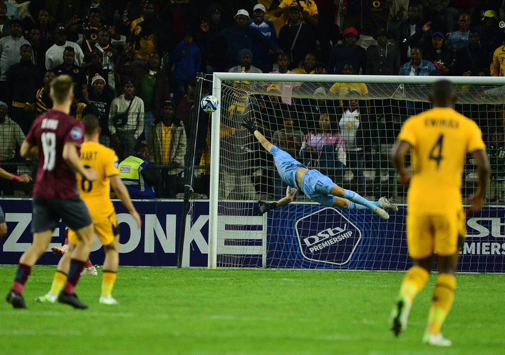 Sage Stephens of Stellenbosch FC can't stop a shot from Pule Mmodi of Kaizer Chiefs during the DStv Premiership match between Stellenbosch FC and Kaizer Chiefs at Athlone Stadium.