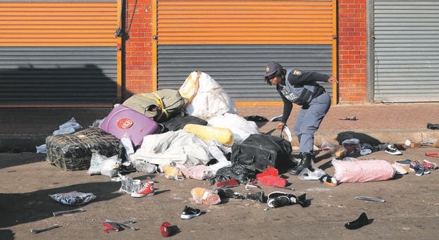  Police conducting a raid in Johannesburg’s CBD, where millions worth of counterfeit goods were seized. Picture: Sandile Ndlovu