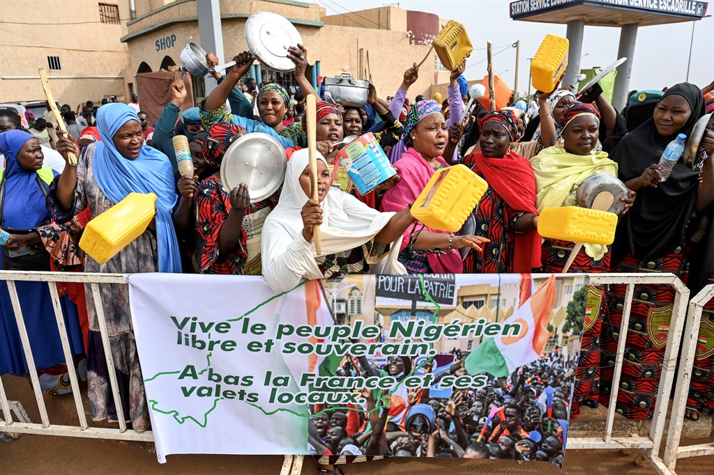 Supporters of Nigers National Council of Safeguard of the Homeland (CNSP) protest outside the Niger and French airbase in Niamey on 30 August 2023 to demand the departure of the French army from Niger. (Photo by - / AFP)