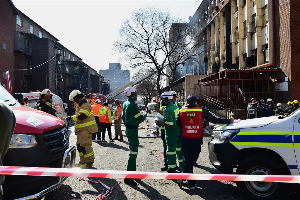Emergency service officials and law enforcement officers had their hands full as they searched for survivors in a building destroyed by fire in the Joburg CBD. Photo by Morapedi Mashashe