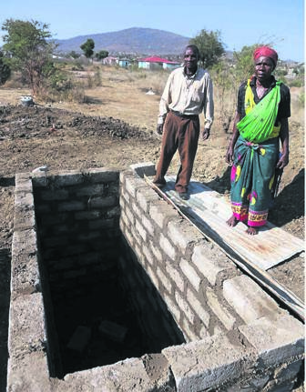 Rackson and Flora Makhubele showing the empty grave where Mbazima was supposed to be buried on Sunday morning.                   Photo by       Joshua Sebola 