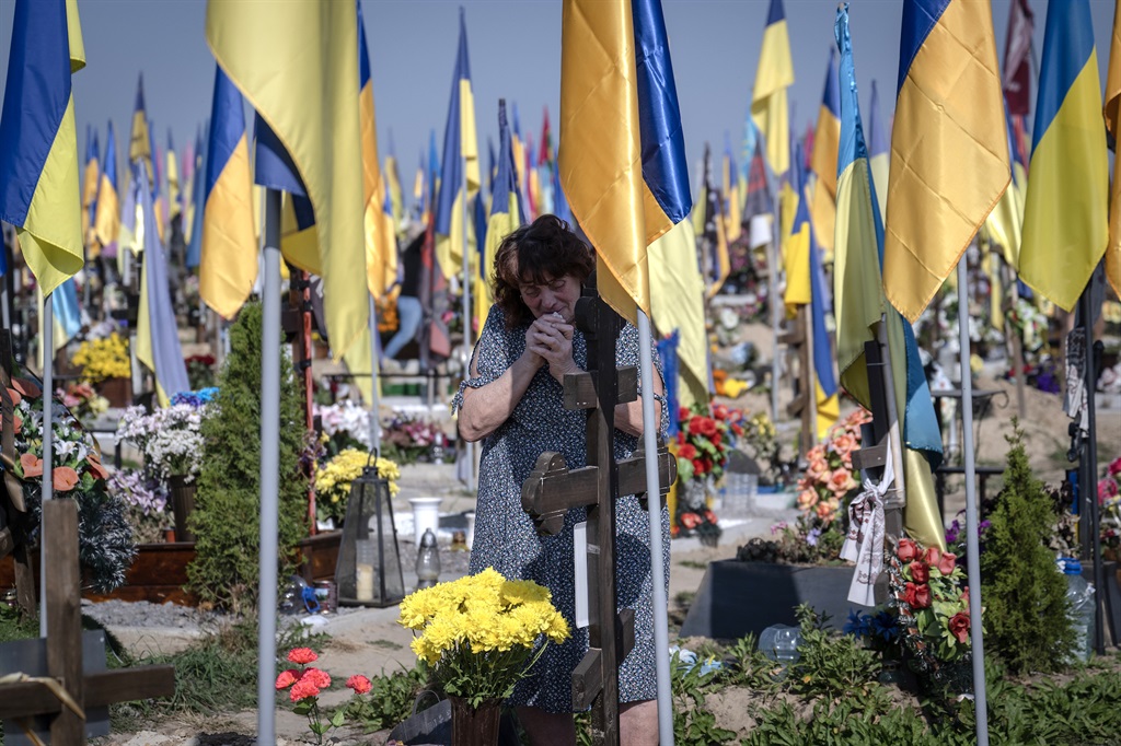 People gather at a cemetery during Ukraine Defenders Day to commemorate the Ukrainian soldiers who lost their lives during the Russia-Ukraine war in Kharkiv, Ukraine on 1 October 2023. (Photo by Ozge Elif Kizil/Anadolu Agency via Getty Images)