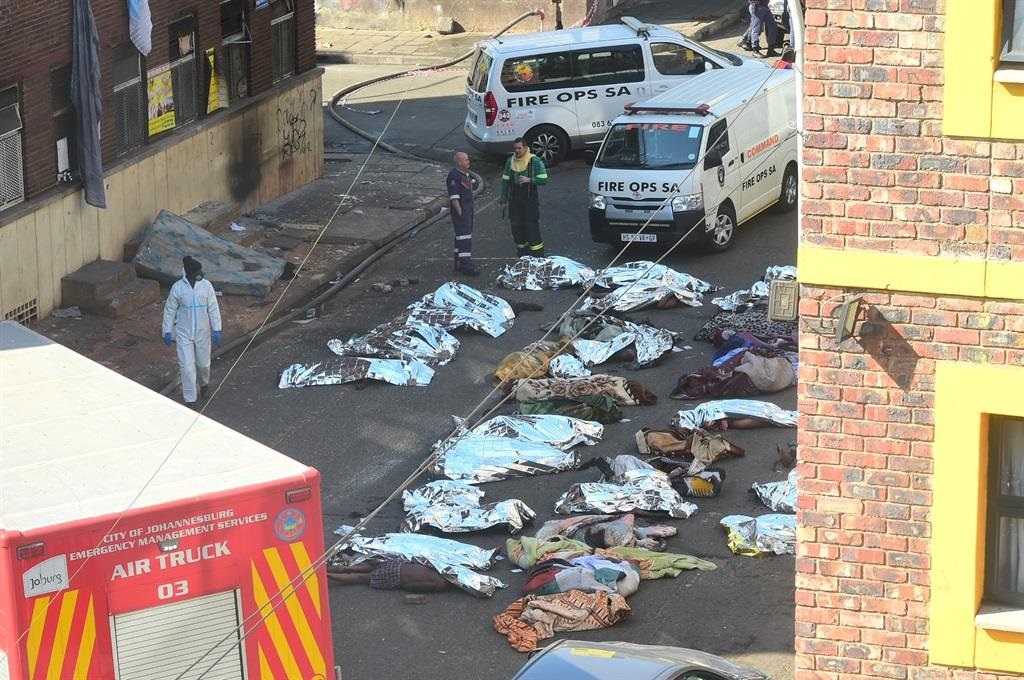 TRAGIC: Some of the bodies of the victims lie on the street in the Joburg CBD on Thursday, 31 August. Photo Morapedi Mashashe
