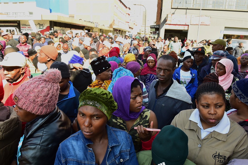 Survivors and onlookers near a suspected hijacked 