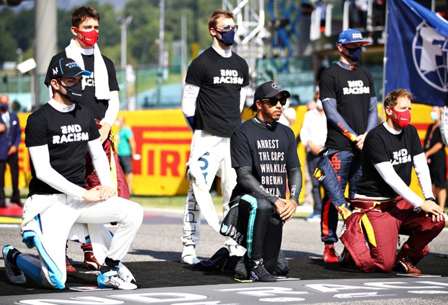 Nicholas Latifi, Lewis Hamilton, and Sebastian Vettel kneel as Max Verstappen, Daniil Kvyat and Charles Leclerc stand in support of ending racism before the F1 Grand Prix of Tuscany at Mugello Circuit on September 13, 2020 in Scarperia, Italy. (Photo by Mark Thompson/Getty Images)