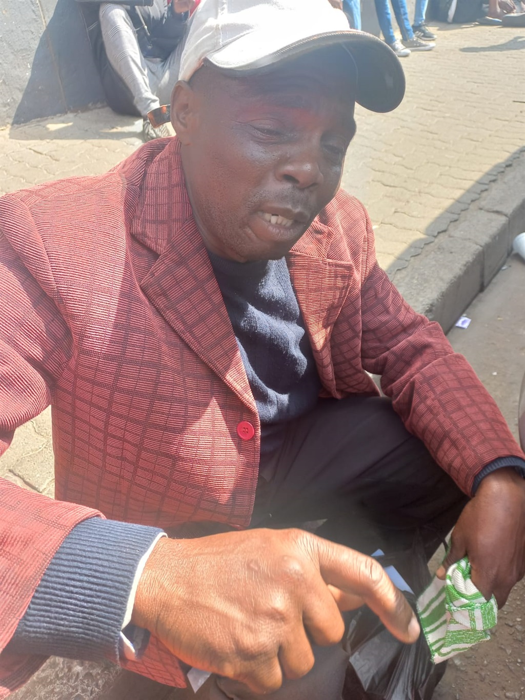 An emotional father, Foster Banda in tears as he is looking for his daughter and granddaughter who lived at Usindiso building.