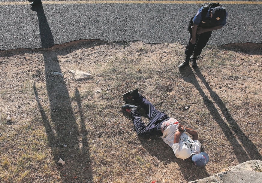 A sting operation conducted by police results in a suspect being caught and cuffed. Picture: Gallo Images 