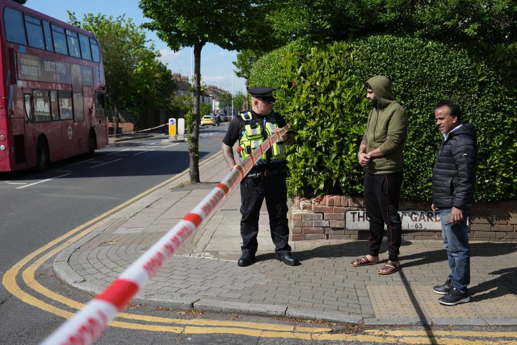 A street is cordoned off after a sword attack on 30 April 2024 in Hainault, England. After a vehicle was driven into a house, a suspect went on to attack other members of the public and two police officers near Hainault Tube Station in North East London. A 36-year-old man was arrested at the scene, and he is in custody. (Carl Court/Getty Images)
