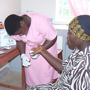 Measuring an HIV patient's CD4 count at the Kyabugimbi Health Center in Uganda. Source: Wikemedia Commons, USAID