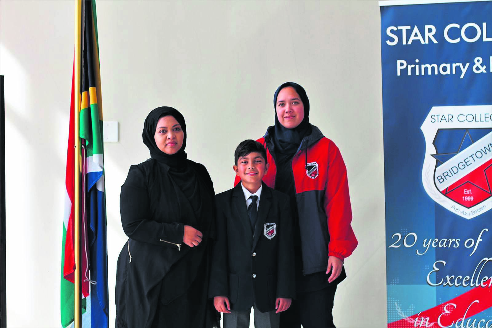 Mikaeel Vallie with Mathematics teacher Thaakirah Isaacs and class teacher Naseerah Hendricks.