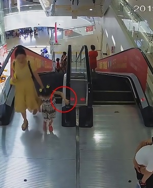 Girl's hand gets sucked in by escalator.  (Photo: ASIA WIRE/MAGAZINEFEATURES.CO.ZA)