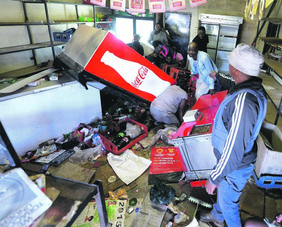 CAUGHT RED-HANDED: Cops had their hands full when looters helped themselves to goods recently. Photo by Trevor Kunene