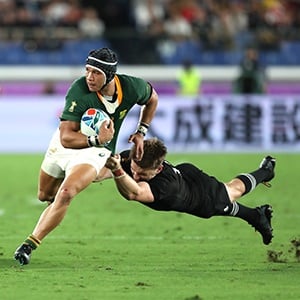 Cheslin Kolbe of South Africa is tackled by Beauden Barrett of New Zealand during the Rugby World Cup 2019 Group B game between New Zealand and South Africa at International Stadium Yokohama on September 21, 2019 in Yokohama, Kanagawa, Japan. (Photo by Mike Hewitt/Getty Images)