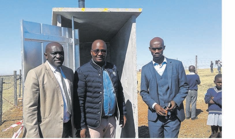 From left: MEC Fundile Gade, Lusanda Sizani and principal Andisa Dunjwa in front of one of the new toilets.     Photo by Mbulelo Sisulu