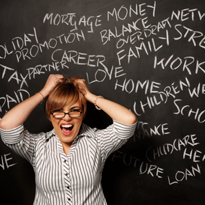 Stressed woman pulling out hair with words on a blackboard