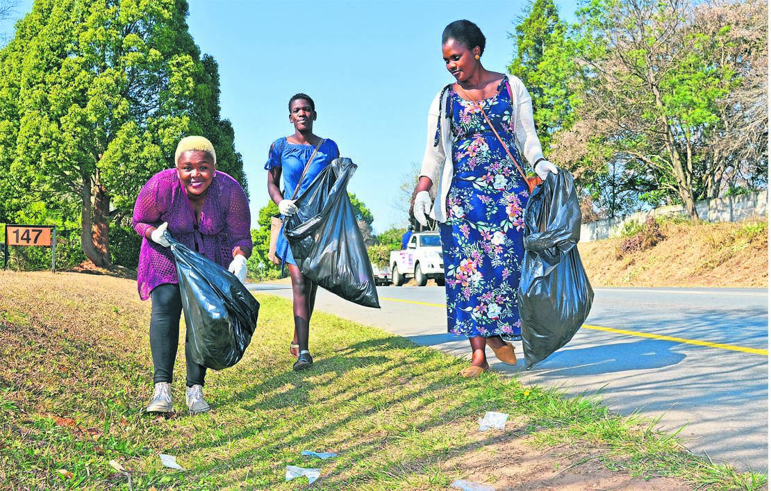 uMngeni Municipality employees (from left) Sanelisiwe Makhaye, Mbalenhle Dlamini and Ncamsile Goge clean up near Cedara after a large amount of litter was left on the road from the Mandela Day Marathon on Sunday. 