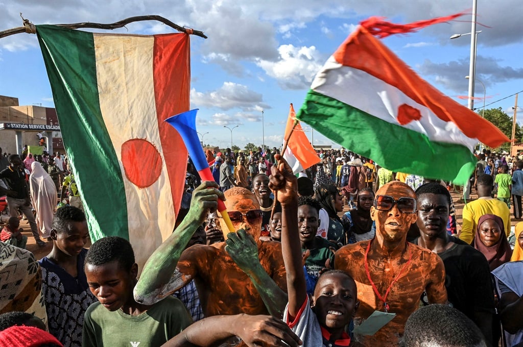 A supporter of Niger's National Council of Safeguard of the Homeland (CNSP) with a vuvuzela outside an airbase in Niamey on 3 September 2023, as protesters gathered to demand the departure of the French army from Niger. (Photo by AFP)