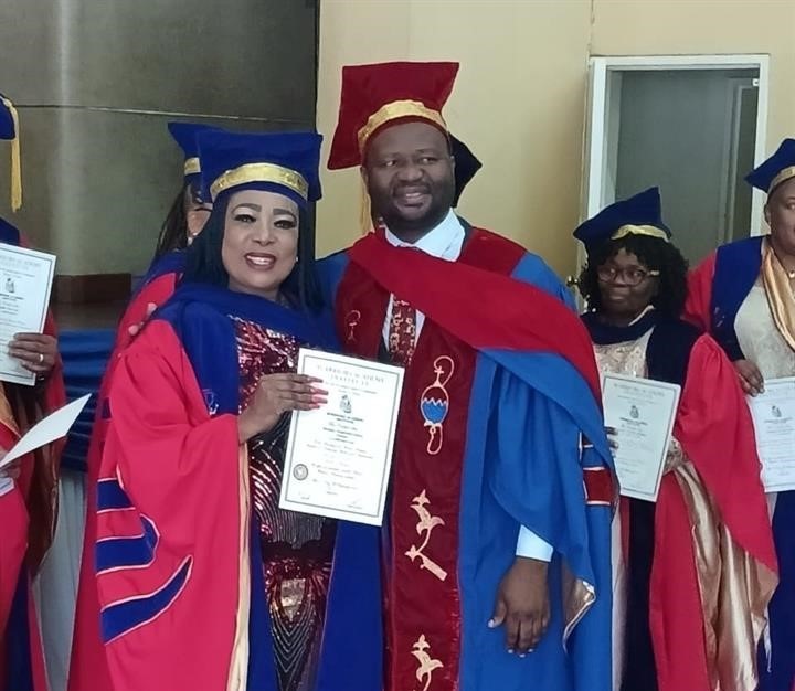 Nozi Nguse with one of the chancellors after getting her doctorate