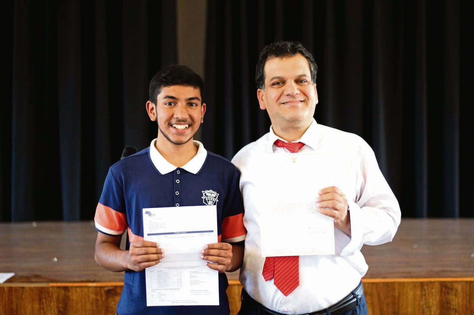 With an impressive 97% aggregate for his 10 distinctions, Faraaz Ahmed Parker is the star pupil at Star College Bridgetown. He is pictured here with the school principal PHOTO: supplied
