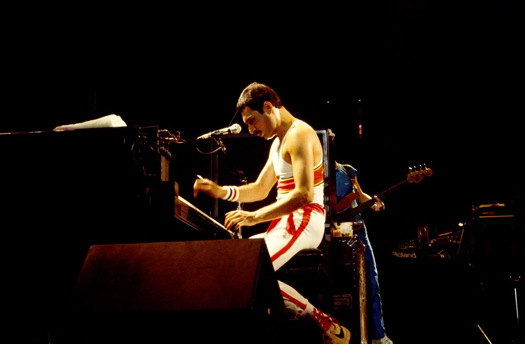 English Rock vocalist Freddie Mercury (1946 - 1991), of the group Queen, plays piano as he performs onstage at Byrne Arena, East Rutherford, New Jersey, August 9, 1982. 