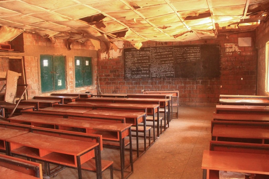 Dilapidated classroom with empty desks after kidna