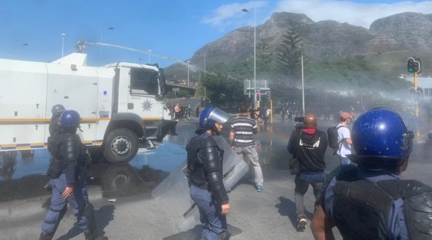 Stun grenades and water cannons in Cape Town CBD. (James De Villiers, Business Insider)