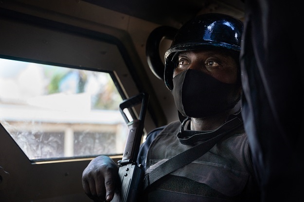 A Rwandan policeman in an armoured vehicle in Cabo