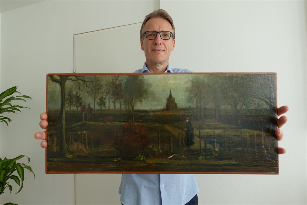 An handout picture released by Dutch art detective Arthur Brand shows a portrait of him posing with the painting title "Parsonage Garden at Nuenen in Spring", painted by Vincent van Gogh in 1884, at his home in Amsterdam on 11 September 2023. 