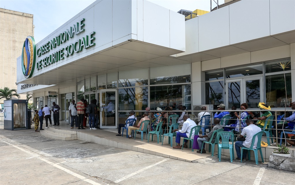 People waiting outside the National Social Security Fund (NSSF) in Libreville on 12 September 2023. (Photo by AFP)