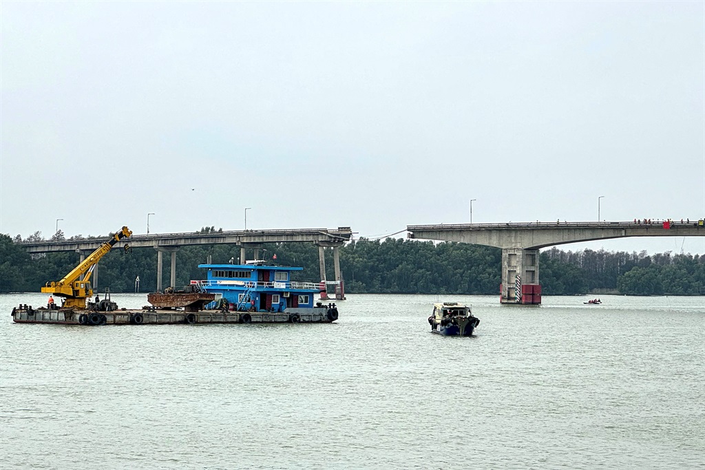 The collapsed section of the Lixinsha bridge over a waterway in Guangzhou, in southern China's Guangdong province on 22 February. A cargo ship struck the bridge, causing cars to plummet into the water.  (Photo by CNS / AFP)