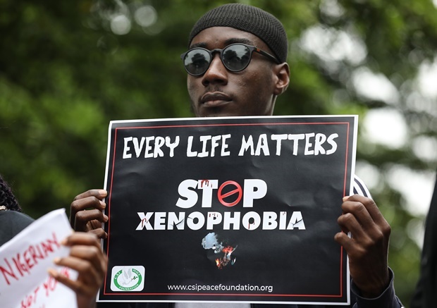 A demonstrator holds a sign during a protest against xenophobia outside of the main gate of the South African High Commission which was shut down to avert reprisal attacks in Abuja. (Kola Sulaimon, AFP)
