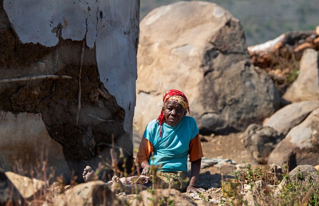 A gogo sitting next to her house in KwaDinda. Photo by Trevor Kunene