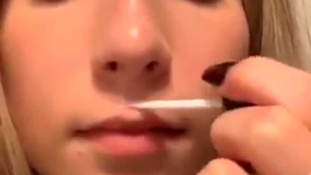 Viral clip of woman using glue to create fuller lips (Photo: Twitter)