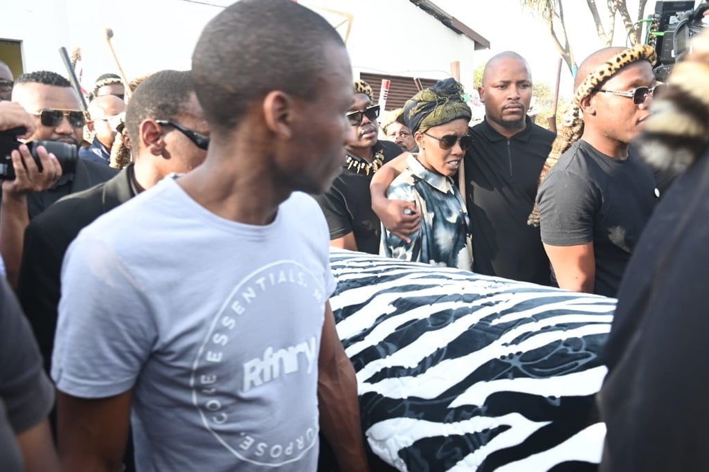 Toya Delazy (wearing sunglasses and a doek) being comforted by the other grandchild as they were taking their grandfather’s remains home from the mortuary. Photo by Jabulani Langa