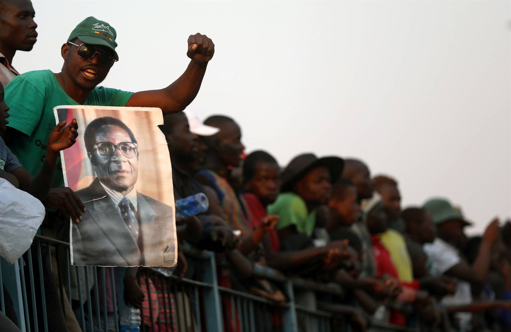 A mourner holds a poster of Robert Mugabe during the viewing of his body as it lies in state at the Rufaro stadium. Picture: Siphiwe Sibeko/Reuters