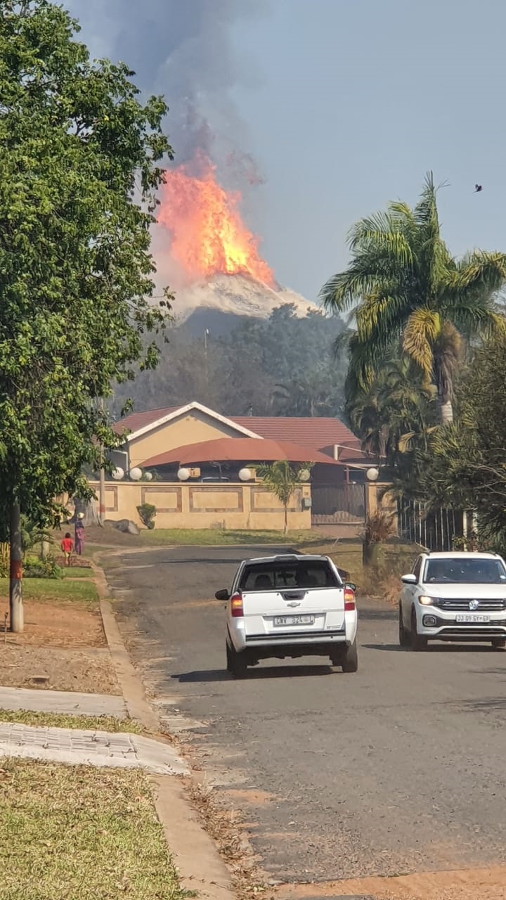 Houses engulfed by flames after a veld fire.   