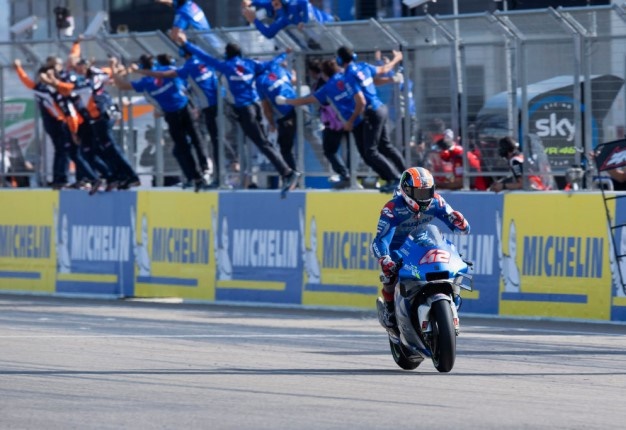 Alex Rins of Team Suzuki cuts the finish lane and celebrates the victory during the MotoGP race during the MotoGP of Aragon. Image: Mirco Lazzari / Getty. 