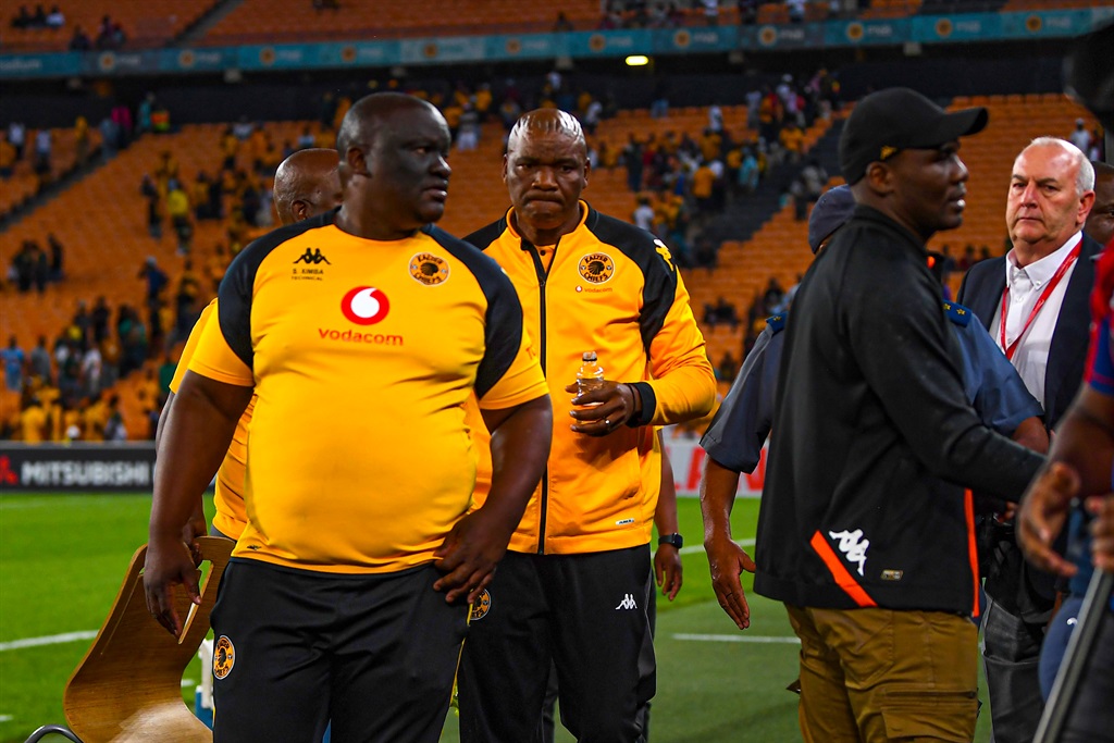 Former Kaizer Chiefs coach Molefi Ntseki escorted by police after fans pelted objects towards him during the Carling Knockout match between against AmaZulu FC.