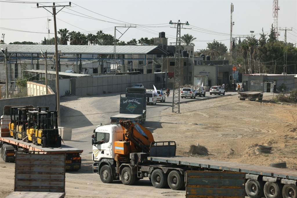 Empty lorries wait on the Palestinian side of the Rafah border crossing to collect humanitarian aid for the Gaza Strip to be delivered from lorries waiting on the Egyptian side of the border on October 21, 2023, amid the ongoing battles between Israel and the Palestinian group Hamas. 