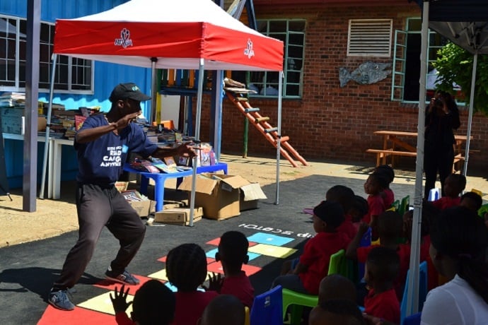 Story sparker Sello Mabaso retells an exciting story to preschoolers at the book donation handover.