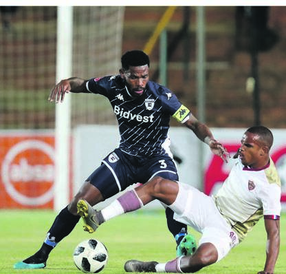 Iqraam Rayners of Stellenbosch feels the wrath of Wits defender Thulani Hlatshwayo Picture: Muzi Ntombela / BackpagePix