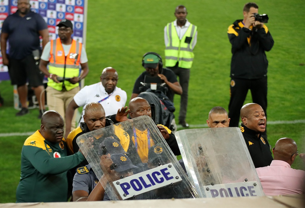 Kaizer Chiefs head coach Molefi Ntseki leaves the Peter Mokaba Stadium pitch under the escort of police and security guards following Amakhosi's defeat to SuperSport United. 