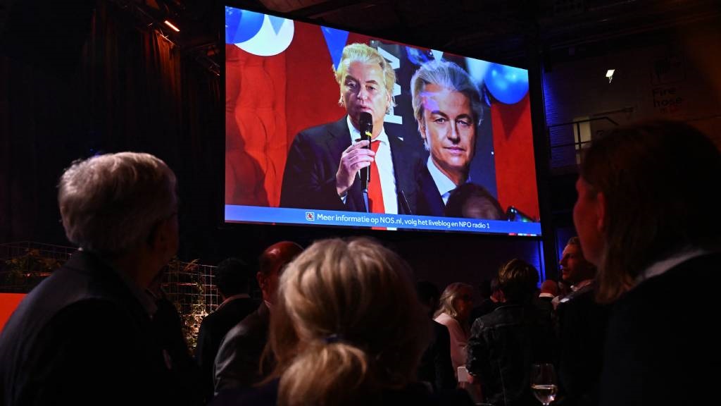 VVD party members watch on a screen Dutch politici