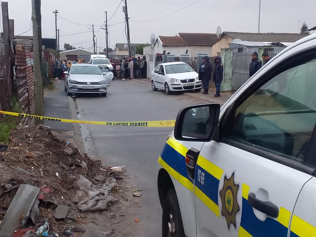 Police and bystanders at the scene of the shooting incident in Gugulethu on Monday afternoon. Photo by Lulekwa Mbadamane