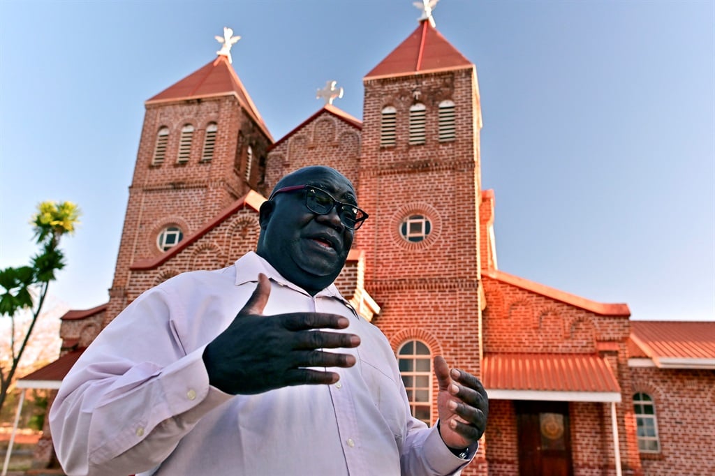 Father Fidelis Mukonori,in front of St. Ignatius Loyola Parish Church Chishawasha, in Mashonaland East, in 2019. 