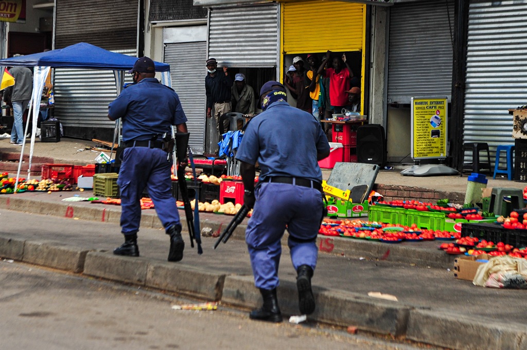 Police monitor the Pan Africa Shopping Mall in Alexandra on Tuesday following clashes between members of the Operation Dudula movement and foreign nationals. 